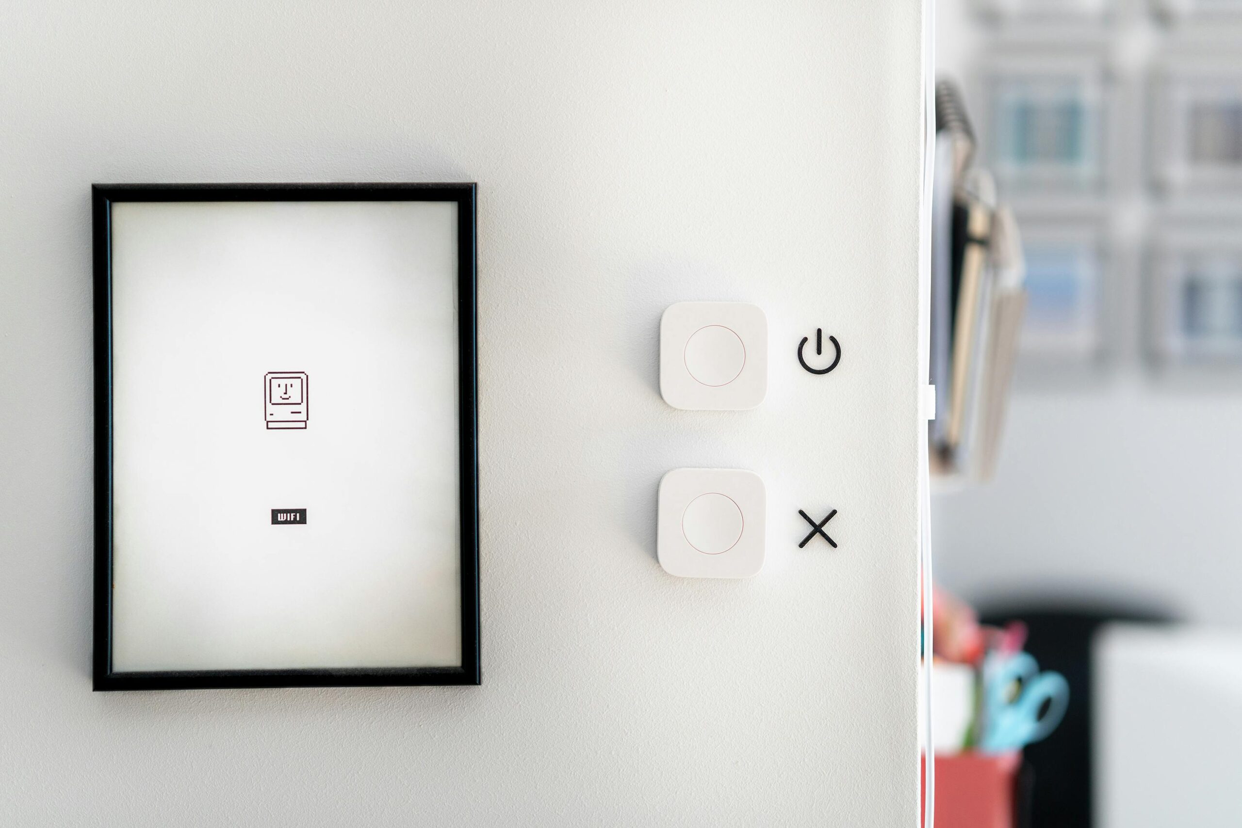 Modern minimalist interior featuring smart home devices and framed art for contemporary design aesthetics.